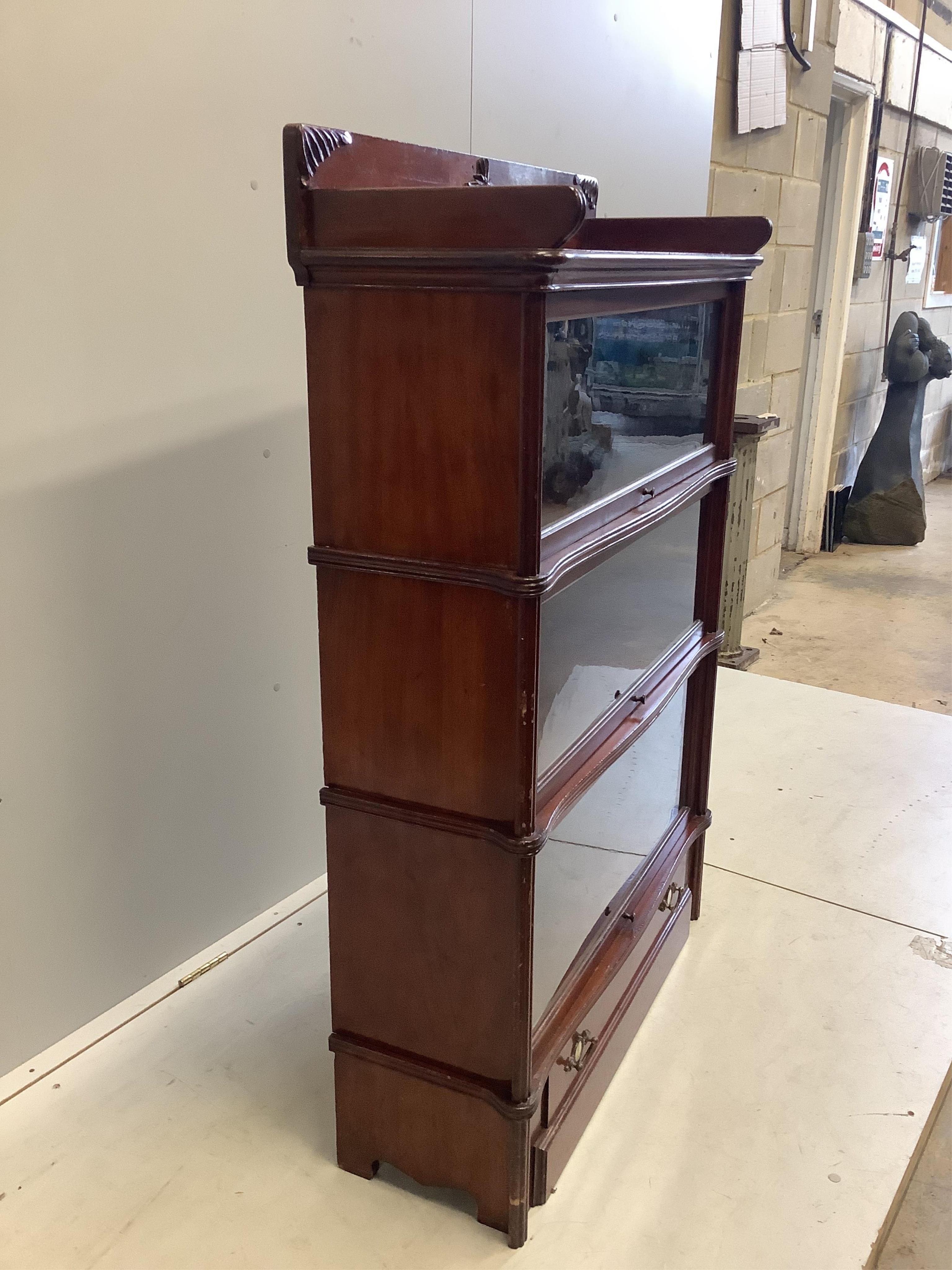 A Globe Wernicke mahogany three section bookcase, width 92cm, depth 33cm, height 135cm. Condition - fair